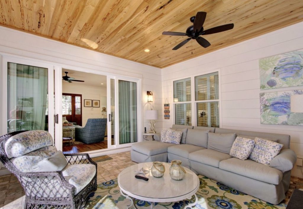 the interior of a living room in a beach house, featuring a casual yet elegant design